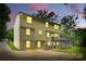 The back of this home offers a deck, a patio underneath and ample lighting at 7016 Wannamaker Ln, Charlotte, NC 28226
