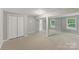 Finished basement offers neutral carpet and paint, bright windows, and closet at 7016 Wannamaker Ln, Charlotte, NC 28226