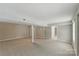 Expansive basement with neutral walls and carpet offers a flexible space, ready for personalization and various uses at 7016 Wannamaker Ln, Charlotte, NC 28226
