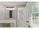 Bathroom vanity with makeup space, drawers, and an open doorway to the commode at 7016 Wannamaker Ln, Charlotte, NC 28226