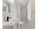 Bright bathroom features a white vanity with sleek black faucet and a window bringing in natural light at 7016 Wannamaker Ln, Charlotte, NC 28226
