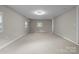Neutral bedroom features plush carpet, ample light, and space for furniture at 7016 Wannamaker Ln, Charlotte, NC 28226