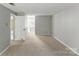 Bedroom with neutral walls, carpet flooring and a door open to the hall and bathroom at 7016 Wannamaker Ln, Charlotte, NC 28226