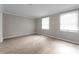 Spacious bedroom filled with natural light from two windows and wood look flooring at 7016 Wannamaker Ln, Charlotte, NC 28226