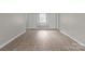 Bedroom with wood-look flooring, window seat, and dual closets at 7016 Wannamaker Ln, Charlotte, NC 28226