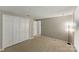 A well-lit bedroom featuring carpet, closet, and an open doorway enhances the sense of space and comfort at 7016 Wannamaker Ln, Charlotte, NC 28226