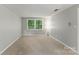 Bedroom with neutral walls, carpet flooring, a window with blinds and a ceiling fan at 7016 Wannamaker Ln, Charlotte, NC 28226