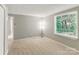 Serene bedroom with a large window and plush carpet, creating a comfortable and inviting retreat at 7016 Wannamaker Ln, Charlotte, NC 28226