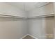 A walk in closet with neutral walls, carpet flooring and hanging shelving at 7016 Wannamaker Ln, Charlotte, NC 28226