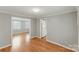 Open dining space featuring hardwood floors, neutral walls, and convenient access to both the kitchen and living areas at 7016 Wannamaker Ln, Charlotte, NC 28226