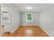 Bright dining area with hardwood floors, neutral walls, and access to the kitchen creating an inviting space at 7016 Wannamaker Ln, Charlotte, NC 28226