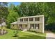 Traditional two-story home boasts a well-manicured lawn and mature trees, providing a serene and inviting curb appeal at 7016 Wannamaker Ln, Charlotte, NC 28226