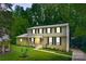 Beautiful two-story home with mature trees, a manicured lawn, and classic black shutters creating a welcoming ambiance at 7016 Wannamaker Ln, Charlotte, NC 28226