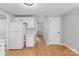 A kitchen area with white cabinets, light countertops, and wood-look flooring at 7016 Wannamaker Ln, Charlotte, NC 28226