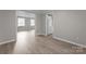 An open living space features wood-look flooring, neutral walls, and natural light at 7016 Wannamaker Ln, Charlotte, NC 28226