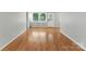 A living room with wood floors, neutral walls, a back door and a window with blinds at 7016 Wannamaker Ln, Charlotte, NC 28226