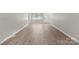 Entryway into a large living room with wood-look flooring at 7016 Wannamaker Ln, Charlotte, NC 28226