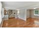 Open living space features hardwood floors and neutral walls, offering versatility and a seamless flow between rooms at 7016 Wannamaker Ln, Charlotte, NC 28226