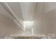 View looking down the carpeted staircase with white walls and a railing, leading to the lower level at 7016 Wannamaker Ln, Charlotte, NC 28226
