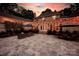 Expansive stone patio with outdoor seating, dining area, landscaped garden, and elegant lighting, ideal for entertaining at 8305 Bar Harbor Ln, Charlotte, NC 28210