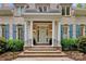 Inviting home entrance with stately columns, brick steps, and manicured landscaping creating a welcoming ambiance at 8305 Bar Harbor Ln, Charlotte, NC 28210