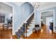 Elegant entryway features a staircase with a patterned runner and access to the living and dining rooms at 8305 Bar Harbor Ln, Charlotte, NC 28210
