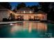 Backyard featuring a spacious patio with outdoor seating, a well-lit pool, and lush greenery for relaxation and entertainment at 8305 Bar Harbor Ln, Charlotte, NC 28210