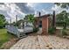 Backyard showcasing a brick home, wooden deck, and stone patio at 85 Sw Myrtle Sw Ave, Concord, NC 28025