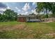 View of the home's backyard with a deck and green lawn on a sunny day at 85 Sw Myrtle Sw Ave, Concord, NC 28025