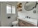 Stylish bathroom featuring a wood vanity, modern fixtures, and an oval mirror at 85 Sw Myrtle Sw Ave, Concord, NC 28025