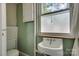 Vintage bathroom featuring a toilet, a charming pedestal sink with a window above at 85 Sw Myrtle Sw Ave, Concord, NC 28025