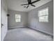 Bedroom features a ceiling fan, plush gray carpet, and two windows at 85 Sw Myrtle Sw Ave, Concord, NC 28025
