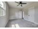 Bedroom features a ceiling fan, plush gray carpet, and natural light from two windows at 85 Sw Myrtle Sw Ave, Concord, NC 28025