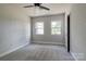 Bedroom with plush gray carpet features a ceiling fan and natural light from two windows at 85 Sw Myrtle Sw Ave, Concord, NC 28025