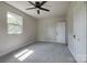 Bedroom features a ceiling fan, plush gray carpet, and natural light from a window at 85 Sw Myrtle Sw Ave, Concord, NC 28025