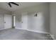Bedroom features a ceiling fan, plush gray carpet, and a closet at 85 Sw Myrtle Sw Ave, Concord, NC 28025