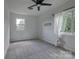 Large bedroom with neutral walls, carpet flooring, ceiling fan and large windows at 85 Sw Myrtle Sw Ave, Concord, NC 28025