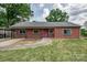 Charming brick home with a pink front door and well-maintained lawn at 85 Sw Myrtle Sw Ave, Concord, NC 28025