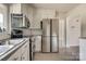 Kitchen with stainless appliances, white cabinets, and laminate flooring at 85 Sw Myrtle Sw Ave, Concord, NC 28025