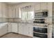 Bright kitchen with white cabinetry, stainless appliances, and wood laminate floors at 85 Sw Myrtle Sw Ave, Concord, NC 28025