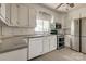 Kitchen with stainless appliances, white cabinets, and laminate flooring at 85 Sw Myrtle Sw Ave, Concord, NC 28025