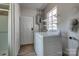 Bright laundry area with white washer and dryer, storage shelves, and easy access to the side yard and adjacent shower at 85 Sw Myrtle Sw Ave, Concord, NC 28025