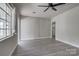 Comfortable living room with a ceiling fan, gray floors, large windows, and lots of natural light at 85 Sw Myrtle Sw Ave, Concord, NC 28025