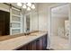 Bathroom features marble counters, dark cabinets and a sliding barn door to the side at 8904 Woodhall Lake Dr, Waxhaw, NC 28173