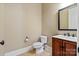Half bath features a vanity with dark wood cabinetry and a framed mirror at 8904 Woodhall Lake Dr, Waxhaw, NC 28173