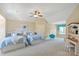 Large, bright bedroom features two beds, carpeted floors and a ceiling fan at 8904 Woodhall Lake Dr, Waxhaw, NC 28173