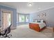 Bedroom with carpeted floors, light blue walls, and many windows for natural light at 8904 Woodhall Lake Dr, Waxhaw, NC 28173