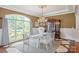 Elegant dining room featuring a crystal chandelier and a large window with natural light at 8904 Woodhall Lake Dr, Waxhaw, NC 28173