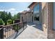 Spacious stone patio with iron railing surrounds the exterior of this beautiful home at 8904 Woodhall Lake Dr, Waxhaw, NC 28173