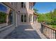 Beautiful stone home features a spacious patio area with iron railing at 8904 Woodhall Lake Dr, Waxhaw, NC 28173